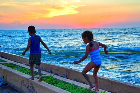 Children Playing at Sunset Photo