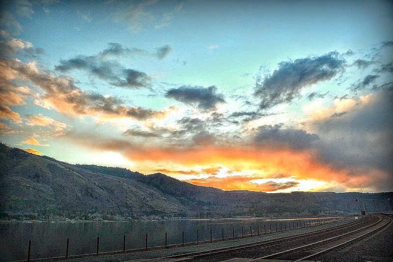 Train Tracks next to lake at Sunset Photo